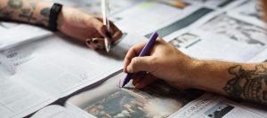 Image of hands writing on newspaper